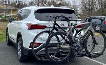 For testing, we're carrying a bike on the back of a white car by SportRack Ridge Hitch-Mount Bike Rack